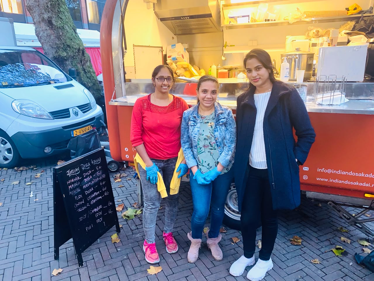 The Indian Dosa Kadai team at their red food truck at the market